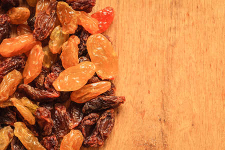 Healthy food organic nutrition. Border frame of raisin on wooden table backgroundの写真素材