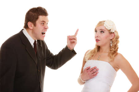 Wedding couple having argument - conflict, bad relationships. Woman bride and angry groom in fight. Isolatedの写真素材