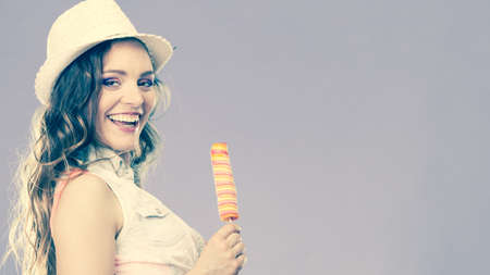 Summer vacation happiness concept. Smiling joyful and cheerful woman fashionable female model eating...