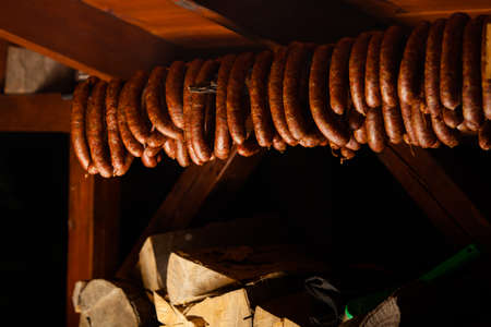 Traditional food. Smoked sausages meat hanging in domestic smokehouse.の写真素材