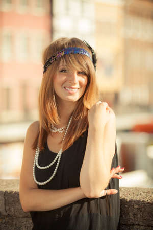 Flapper girl. Retro style fashion vintage woman from roaring 1920s outdoor on the street. Old town...
