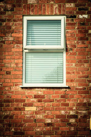 Architecture detail. Old brick wall with window blinds. Outdoor