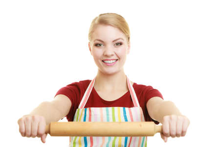 Happy housewife or baker chef wearing kitchen apron holds baking rolling pin studio picture isolated on whiteの写真素材