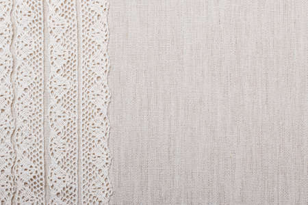 Lace ribbon on natural linen, bright cloth fabric . Border frameの写真素材