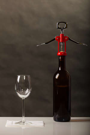 Opening of bottle of wine with corkscrew openerの写真素材