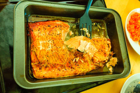 Seafood. Grilled salmon steak with herbs and spices on table.の写真素材