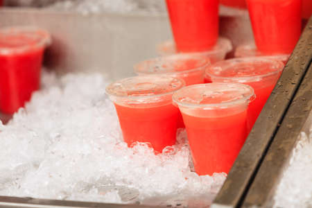 Closeup food stall outdoor on street, cold fruit juice drink takeaway at London marketの写真素材