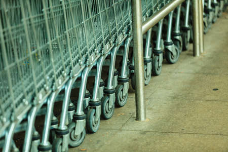 Row of empty shopping cart trolley. Market grocery shop and retail concept. Outdoor.の写真素材