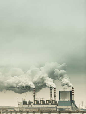 Energy. Smoke from chimney of power plant or station. Industrial landscape. Autumnal foggy day