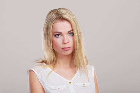 Loneliness stress depression. Sad unhappy girl portrait on grayの写真素材