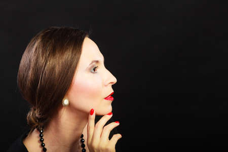 Fashion beauty and elegance concept. Woman retro style face profile. Elegant lady hair styling red lips on blackの写真素材