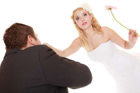 Wedding day. Male groom kissing hand of female bride isolated on white. Romantic gestureの写真素材