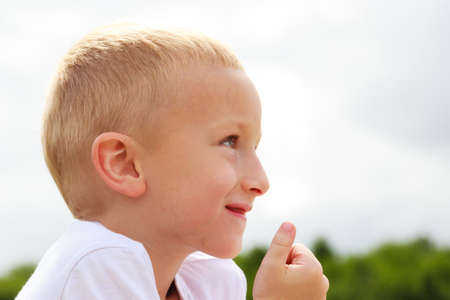 Closeup of smiling child kid outdoor. Happy childhood.の写真素材