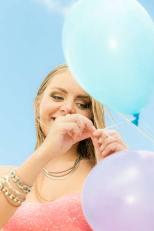Summer holidays, celebration and lifestyle concept - Closeup beautiful woman teen girl with colorful balloons outside blue sky backgroundの写真素材