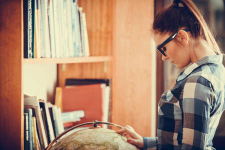 Education travel and geography concept. Hipster lovely woman female student in blue glasses in...