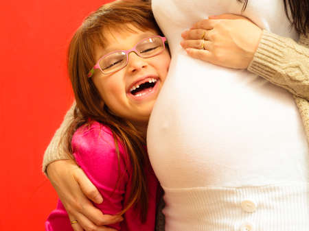Pregnancy, motherhood and happiness concept. pregnant woman awaiting her second child, little cute...