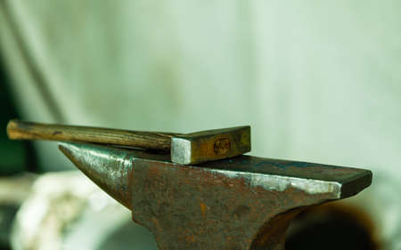 Tools - hammer and anvil used by a blacksmith in old shopの写真素材
