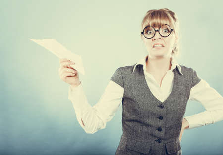 Fly fear metaphor, aerophobia concept. Business woman holding airplane in hand.の写真素材