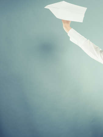 Flight travel or aerophobia concept. Female hand holding paper airplane, copy space for textの写真素材
