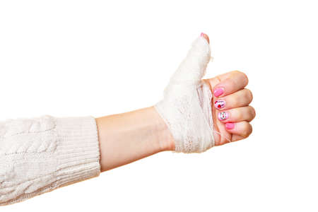 wounded female hand tied elastic bandage, human injury finger on white の写真素材