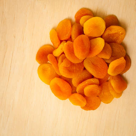 Healthy nutrition diet. Dried apricots set on wooden table .の写真素材