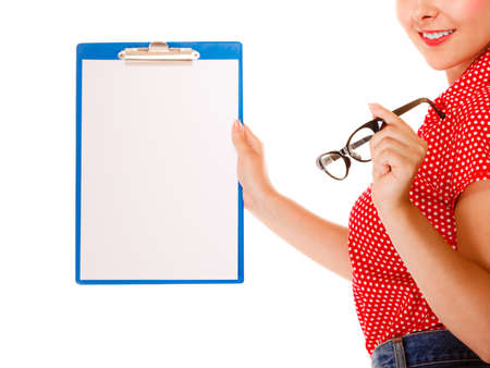 woman retro style holding glasses and clipboard with empty blank sign copy space for text, studio shot, isolated on whiteの写真素材