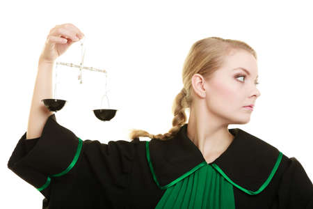 Law court concept. Woman lawyer attorney wearing classic polish black green gown holds scales. Femida - symbol sign of justice. isolated on whiteの写真素材