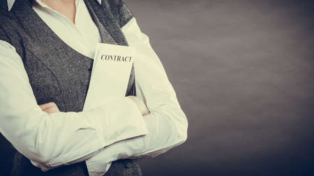 Business documents legal concept - closeup businesswoman holding contract in handの写真素材