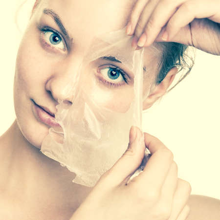 Beauty skin care cosmetics and health concept. Closeup young woman face, girl removing facial peel...