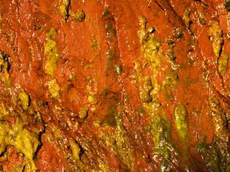 Background of natural wet orange stone wall texture rough rock surface