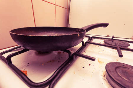 Housework, hygiene and cleaning concept. Dirt at home. Dirty filthy gas stove with used kitchen...