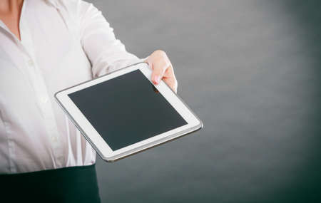 Human hand holding pc tablet. Modern technology.の写真素材