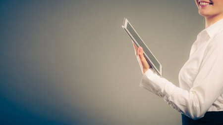 Closeup of human reading and learning with ebook digital tablet studying for exam. Education leisure. の写真素材