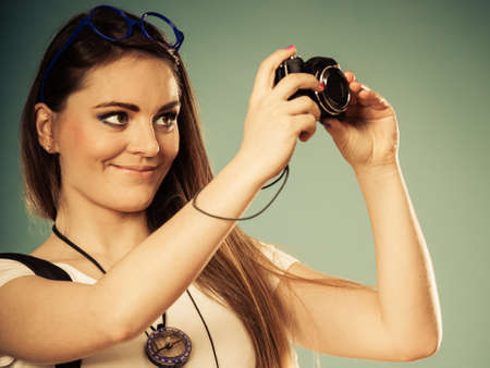 Travel and tourism active lifestyle concept. Tourist woman with backpack taking photo with camera