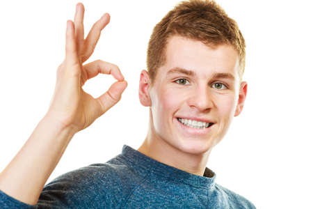 Happiness concept. Happy young man showing ok hand sign gesture isolated on white backgroundの写真素材