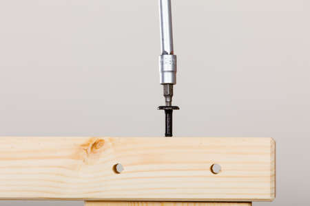 Assembling wooden furniture using screwdriver. DIY. Home improvement.