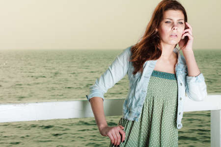 Holidays summer relaxation concept. Young woman relaxing on pier outdoorの写真素材