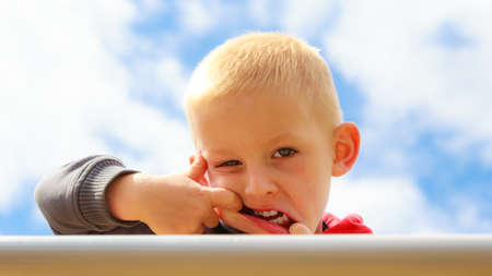 Funny child kid making silly face. Happy boy having fun. Childhood expression.の写真素材