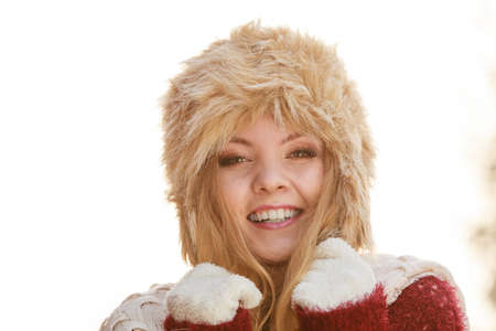Portrait of pretty smiling fashionable woman. Happy gorgeous young girl in fur winter hat. Autumn fall fashion.の写真素材