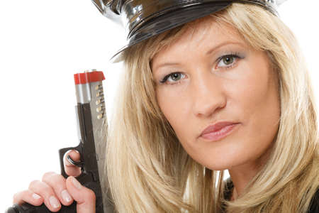 blonde female policewoman cop posing with gun handgun isolated on white backgroundの写真素材