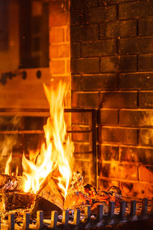 Closeup of burning fire wood in home fireplace.の写真素材