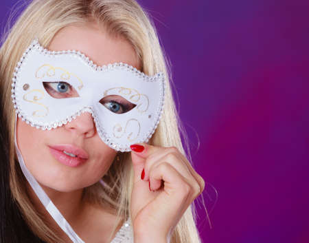 Holidays, people and celebration concept. Closeup woman face caucasian blonde girl with white carnival maskの写真素材