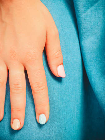Close up of woman girl hand with color nail polish. Manicure cosmetic beauty treatment.の写真素材