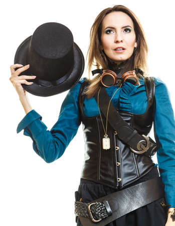 Young steampunk islolated girl on white holding fancy hat. Fantasy old fashion with stylish topper and goggle.の写真素材
