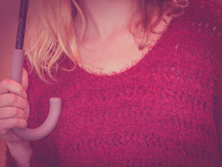 Close up of fashion woman girl in maroon sweater with umbrella.の写真素材