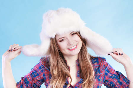 Young woman wearing fluffy cap. Smiling teenage, cold time. Having funの写真素材