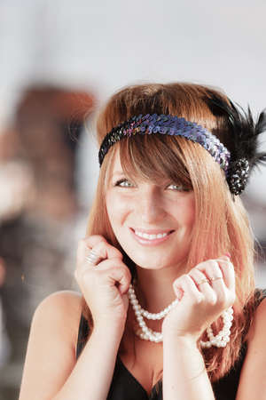 Flapper girl portrait. Retro style fashion vintage woman from roaring 1920s in headband with string...