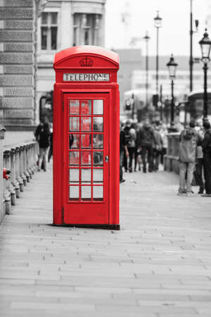 Traditional old style red telephone box, british phone booth in London England UK. Black and white street.の写真素材