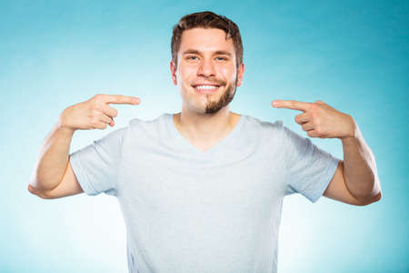 Portrait of happy man with half shaved face beard hair. Smiling handsome guy on blue. Skin care and hygiene.の写真素材