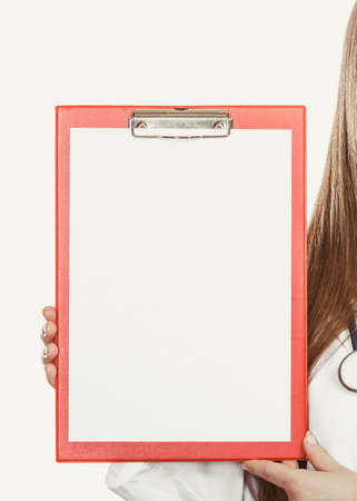 Medical doctor with stethoscope and clipboard. Professional health care advertisement.の写真素材